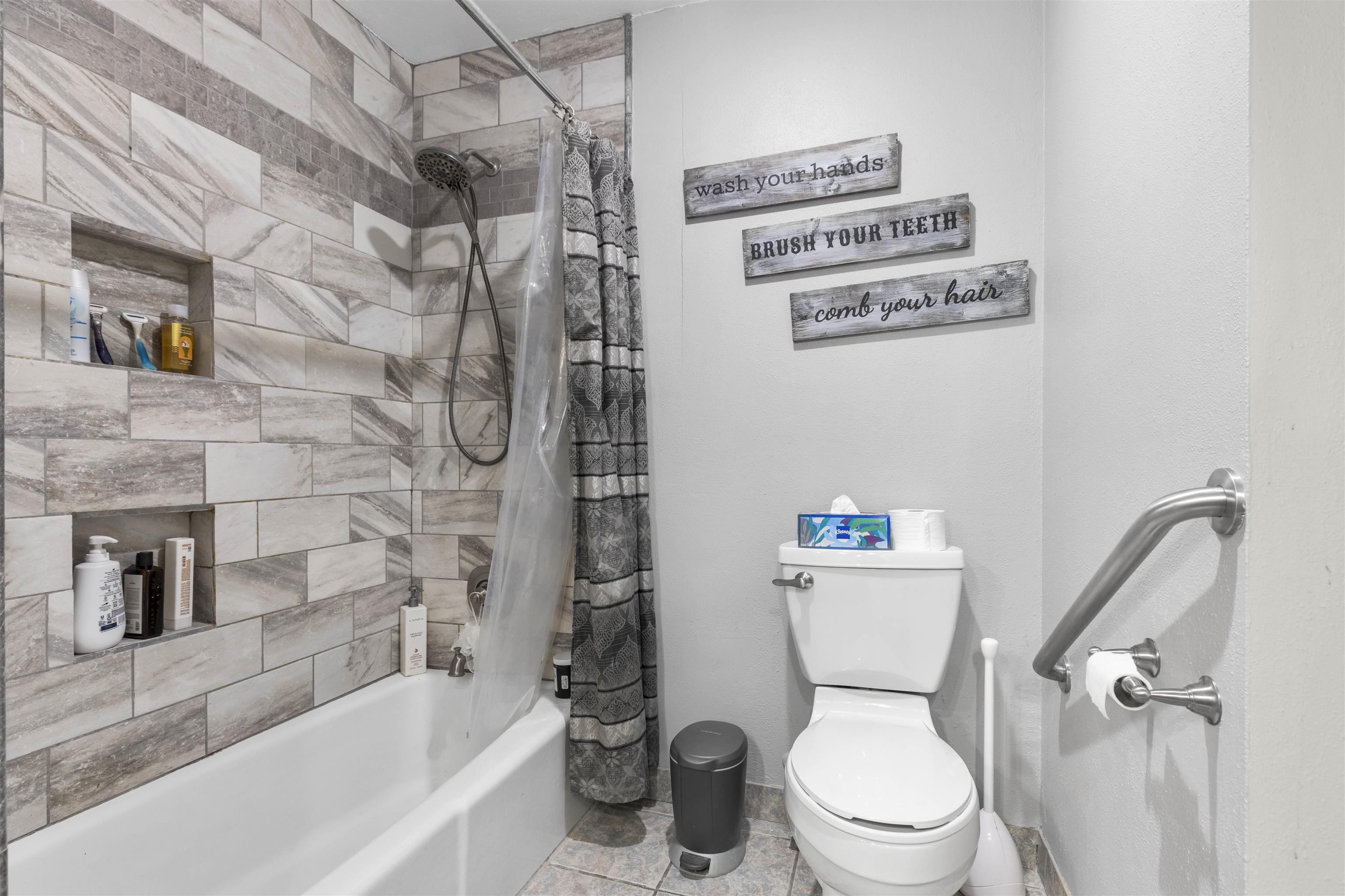 4969 Brookview Road Rockford, IL 61107 - Photo 16 of 34 a white toilet sitting next to a bath tub