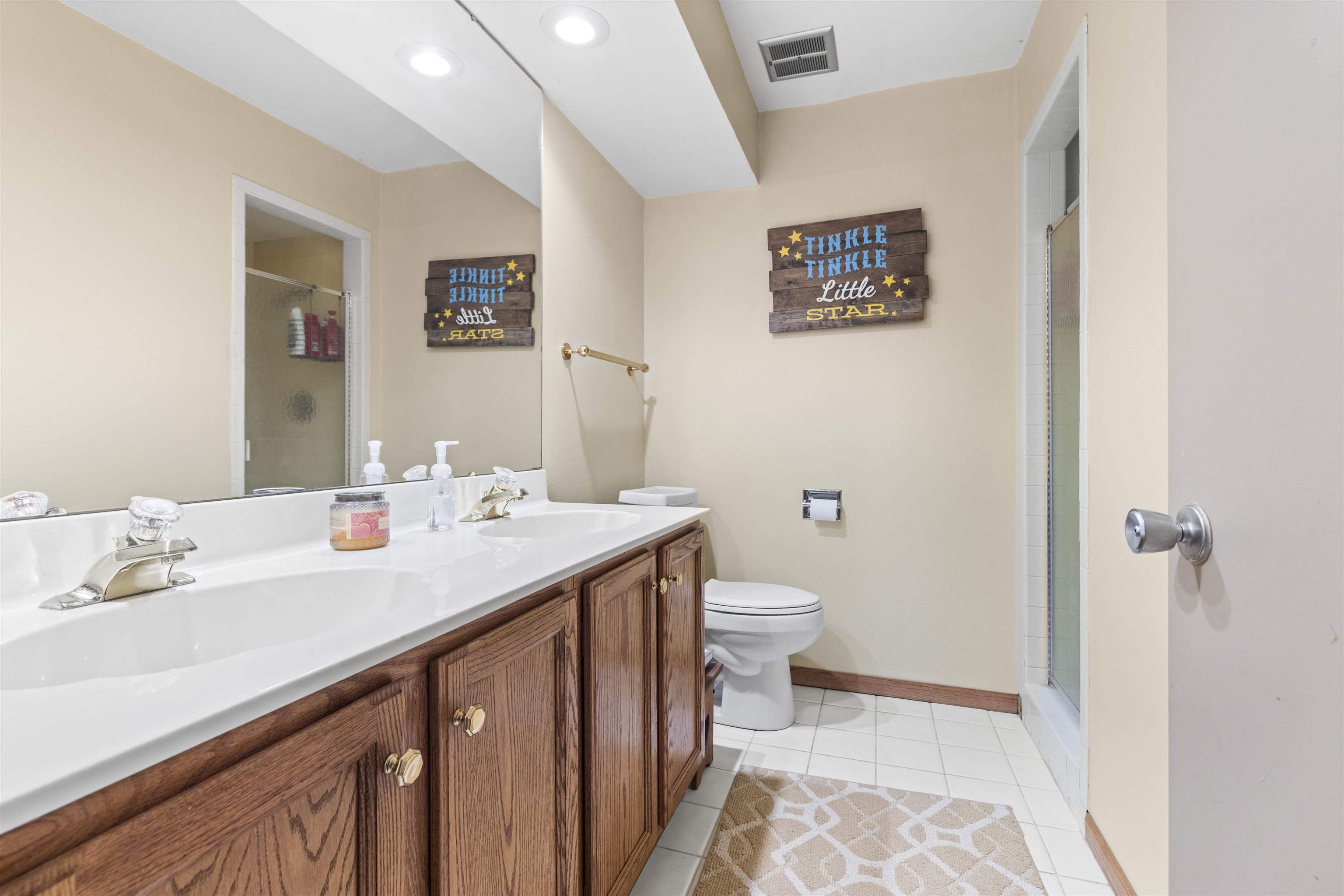 4969 Brookview Road Rockford, IL 61107 - Photo 31 of 34 a bathroom with a sink a toilet a mirror and shower