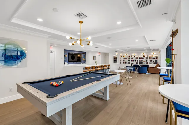 a room with pool table and a chandelier