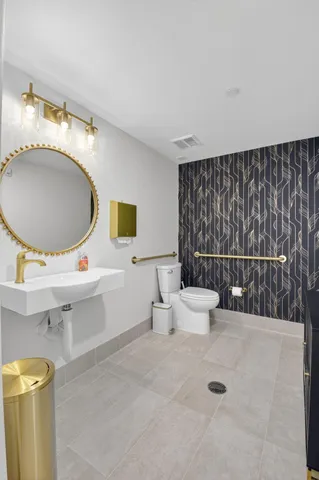 a room with gym equipment and large mirror