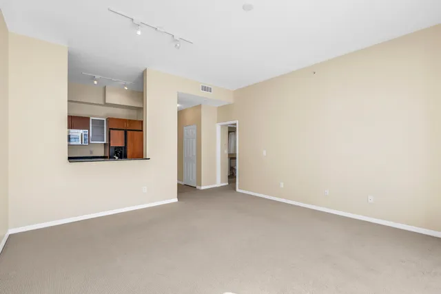 a view of a big room with wooden cabinet and windows