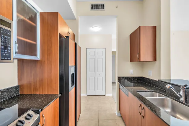 a kitchen with a sink stove and refrigerator