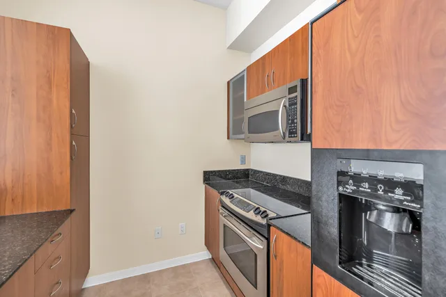 a kitchen with stainless steel appliances granite countertop a stove and a microwave