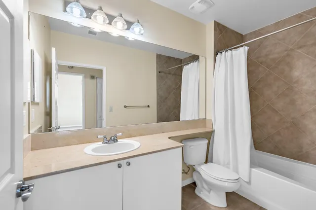 a bathroom with a sink toilet a mirror and shower