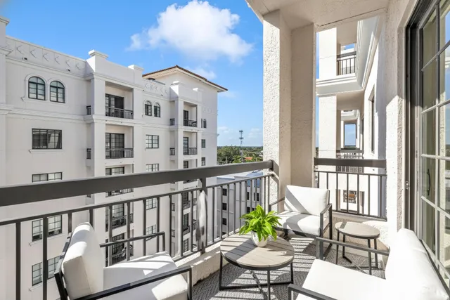 a view of a chair and table in the balcony