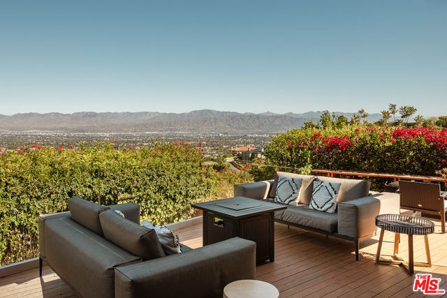 a terrace with outdoor seating and city view