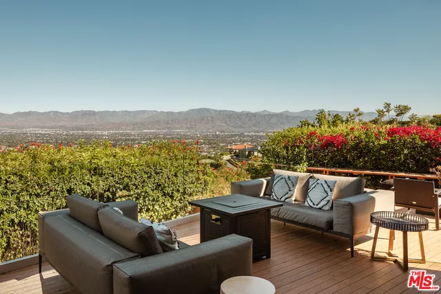 a terrace with outdoor seating and city view