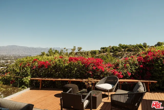 a view of a chairs and table in the patio