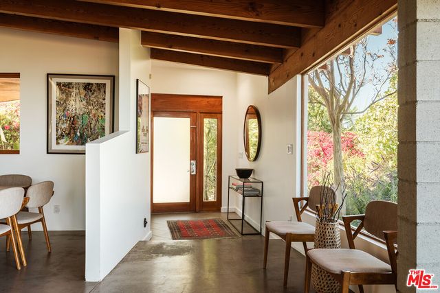 a view of a livingroom with furniture and a window