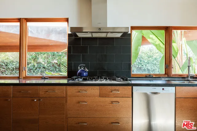 a kitchen with a sink and large window
