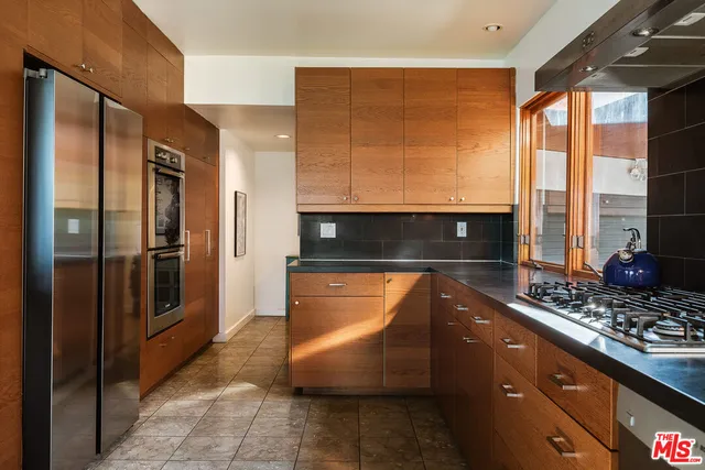 a kitchen with stainless steel appliances granite countertop a refrigerator and a stove