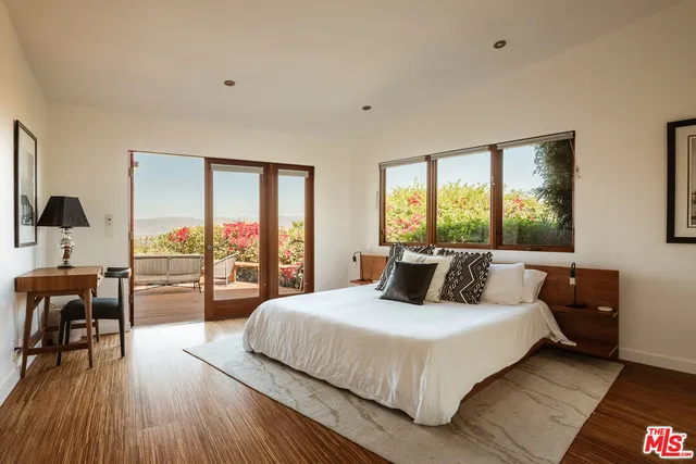 a bathroom with a tub a sink and mirror