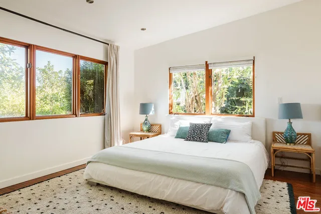a bathroom with a sink mirror and a window