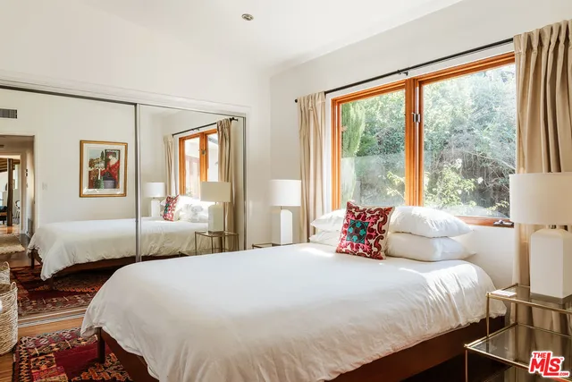 a bedroom with a bed and window