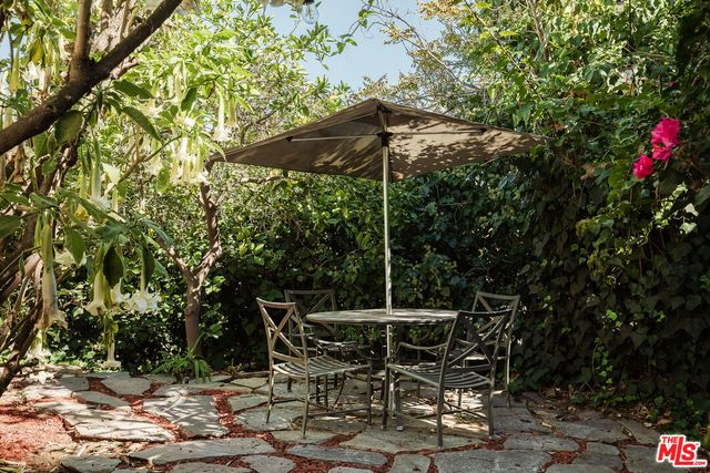 a view of a house with backyard sitting area and garden