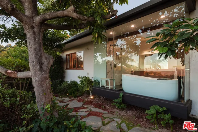 a view of a house with backyard and a sitting area
