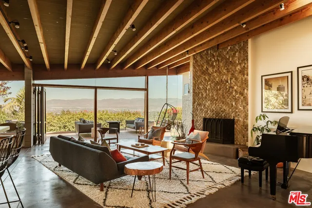 a living room with furniture and a floor to ceiling window