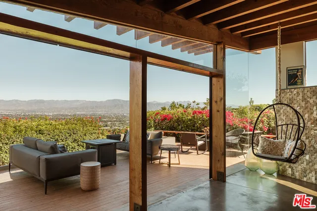 a view of a balcony with chairs and a table