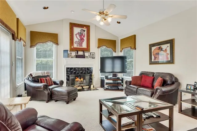 a living room with furniture a fireplace and a flat screen tv