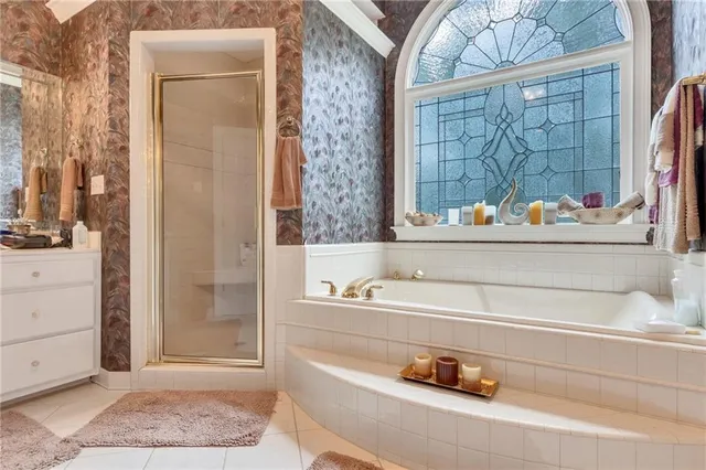 a bathroom with a tub sink and mirror