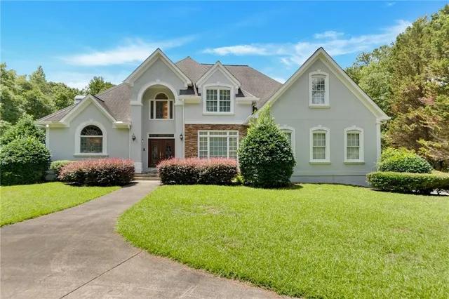 a front view of a house with a yard