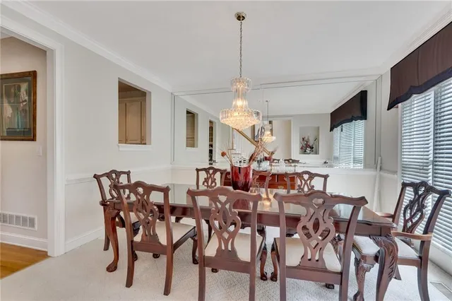 a view of a dining room with furniture and chandelier