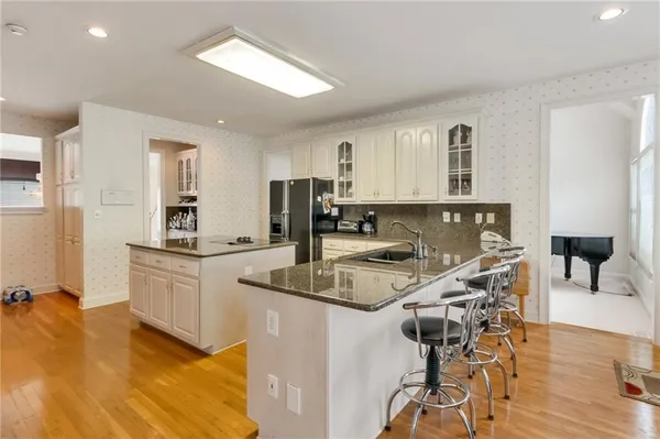 a kitchen with a table chairs refrigerator and cabinets