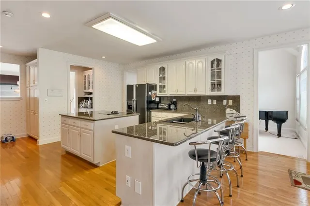 a kitchen with a table chairs refrigerator and cabinets