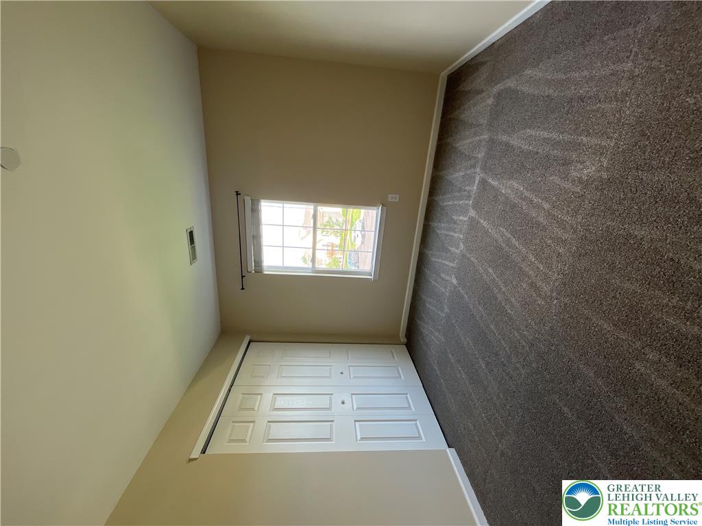 Plush wall-to-wall carpeting and a wide multi-panel closet anchor this comfortable bedroom space.