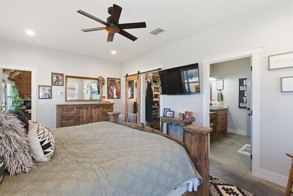 1734 Davis Road Lipan, TX 76462 - Photo 12 of 40 a bedroom with furniture and a flat screen tv