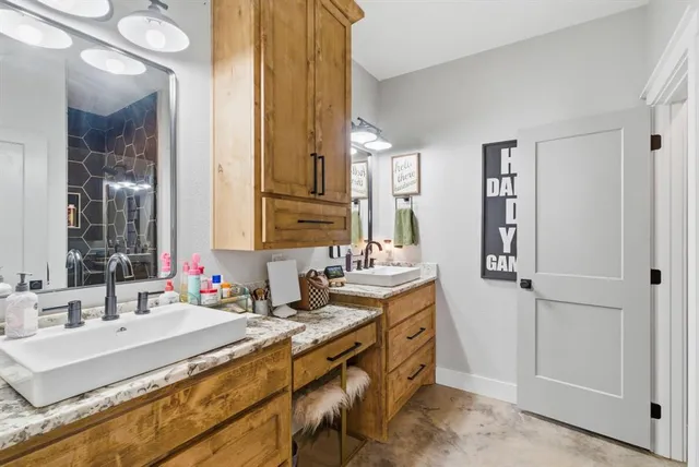 a bathroom with double vanity sinks a mirror and a shower