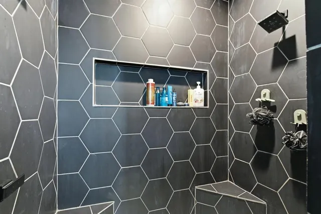 an outdoor space with lots of white walls and a shower