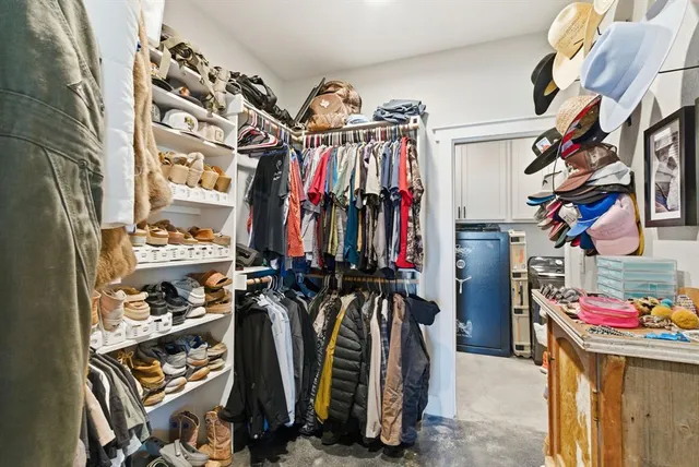 a view of walk in closet with clothes