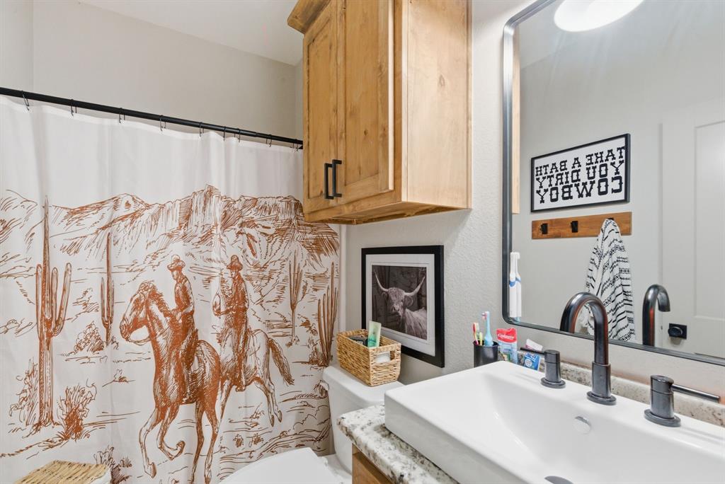 1734 Davis Road Lipan, TX 76462 - Photo 20 of 40 a bathroom with a sink and a mirror