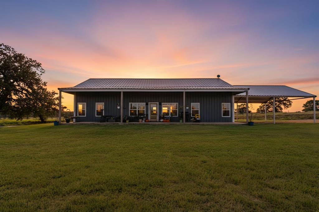 1734 Davis Road Lipan, TX 76462 - Photo 2 of 40 a front view of a house with a garden
