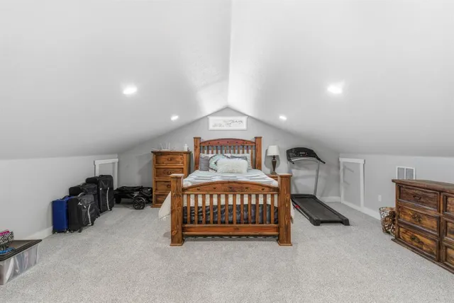 a bedroom with a bed and a tv