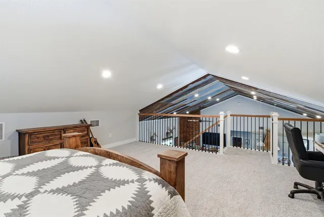 a bedroom with furniture and a large window