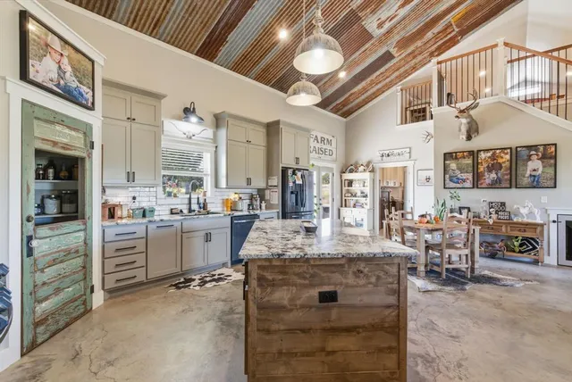 a large white kitchen with a large window