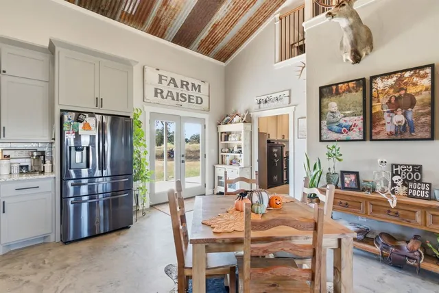 a kitchen with stainless steel appliances kitchen island granite countertop a refrigerator and microwave