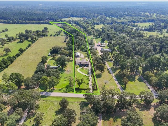 an aerial view of a houses with a lake view