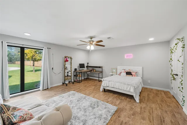 a bedroom with furniture and a large window