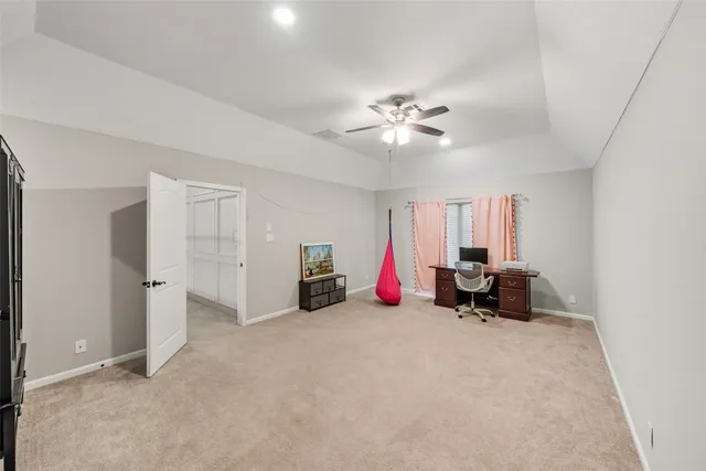 a view of a room with gym equipment and a chandelier