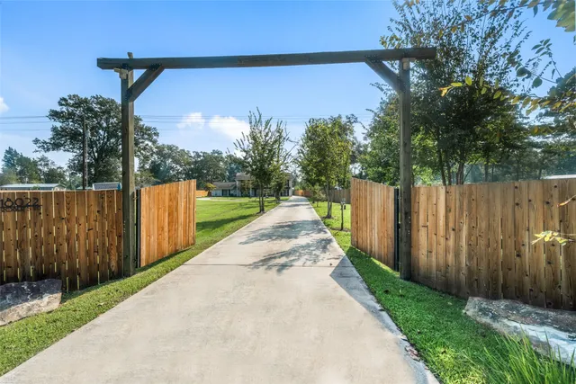 a view of a pathway with a wooden fence