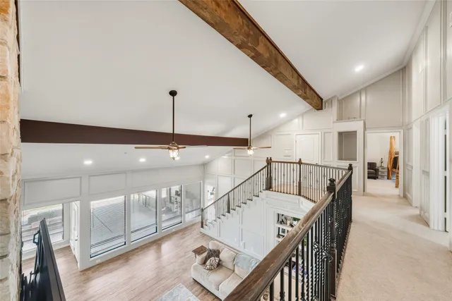 a living room with table tennis and stairs