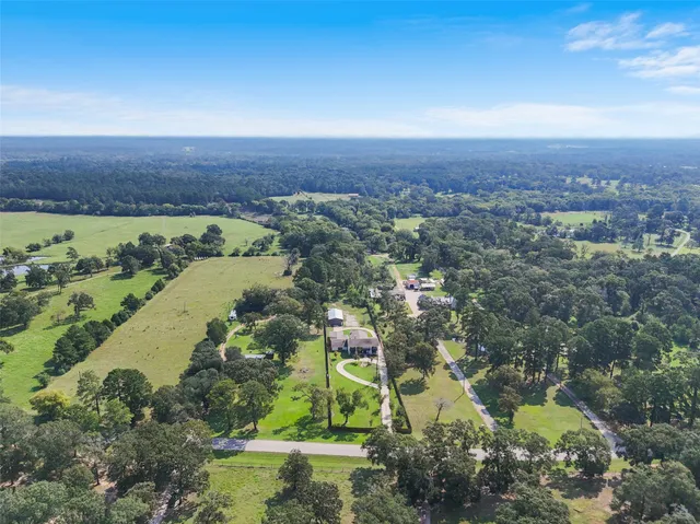 an aerial view of residential house with outdoor space and lake view