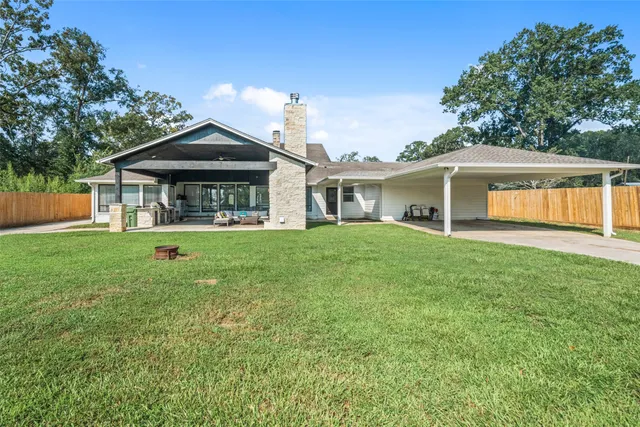 a front view of a house with a yard and trees