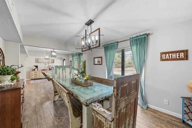 a view of a dining room with furniture and a chandelier