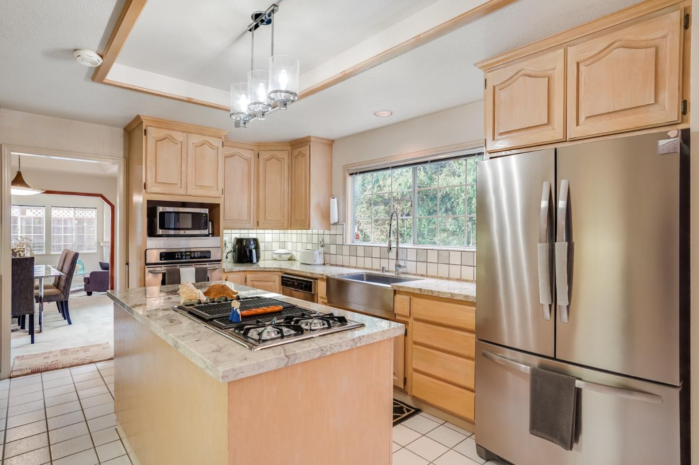 1383 Van Dusen Lane Campbell, CA 95008 - Photo 13 of 58 a kitchen with stainless steel appliances granite countertop a refrigerator a stove a sink and a refrigerator with wooden floor