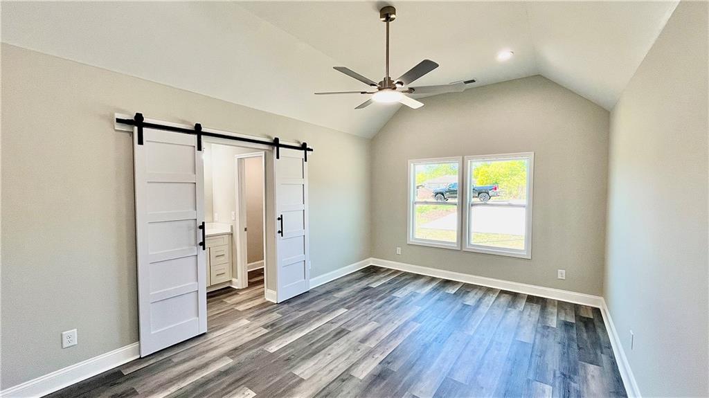 5 Green Road Griffin, GA 30224 - Photo 17 of 34 a view of an empty room with a window and wooden floor