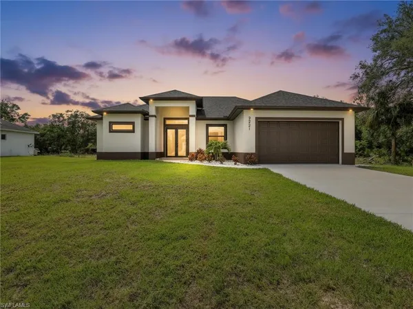 a front view of a house with yard and green space